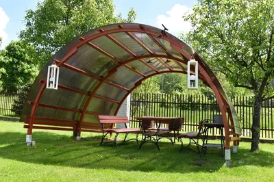 a gazebo with tables and chairs in the grass at Pokoje pod Śnieżnicą in Kasina Wielka