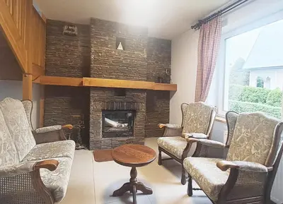 a living room with chairs and a fireplace at Mars 5 in Limanowa