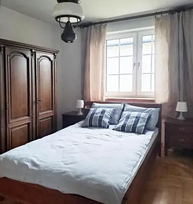a bedroom with a bed with two pillows and a window at Mars 5 in Limanowa