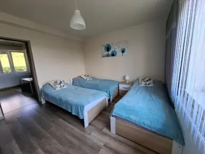 a bedroom with two beds and a window at Ważka - pokoje do wynajęcia in Targoszów