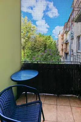 a blue table and a chair on a balcony at Crystal in Kraków