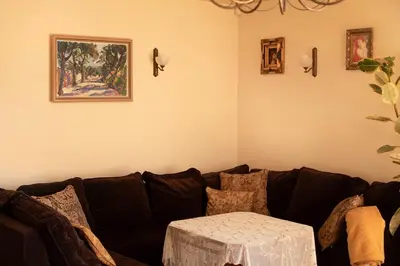 a living room with a black couch with a table at Crystal in Kraków