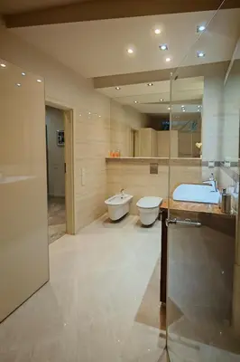 a bathroom with a tub and a toilet and a sink at Crystal in Kraków