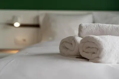 a pile of towels sitting on top of a bed at Przedwiośnie Chic Harmony Apartment by BookingHost in Kraków