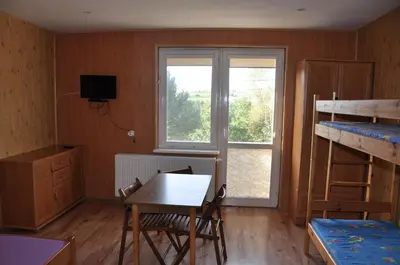 a room with a desk and a table and a bunk bed at Grodzisko11 in Skała