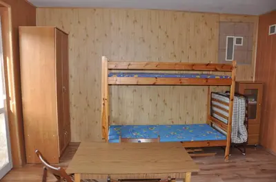 a room with two bunk beds and a table at Grodzisko11 in Skała