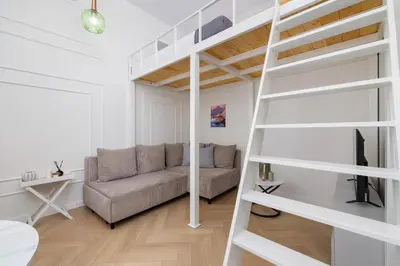 a living room with a couch and a loft bed at Apartment with balcony - Berka Joselewicza 5 in Kraków