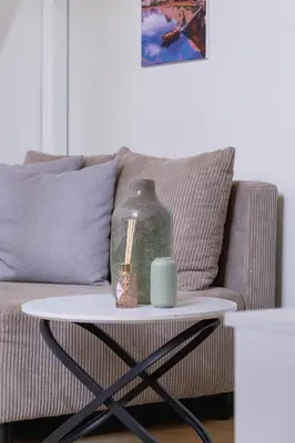 a coffee table with a vase on top of a couch at Apartment with balcony - Berka Joselewicza 5 in Kraków