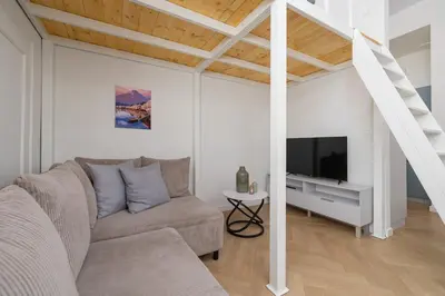 a living room with a couch and a tv at Apartment with balcony - Berka Joselewicza 5 in Kraków