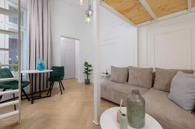 a living room with a couch and a table at Apartment with balcony - Berka Joselewicza 5 in Kraków