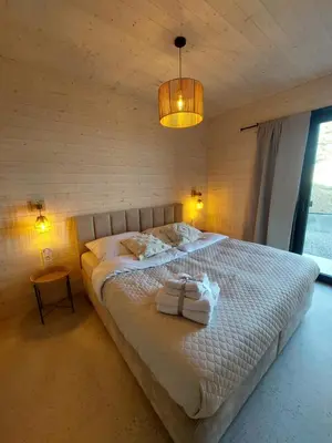 a bedroom with a large bed with a wooden ceiling at GOLaskowa in Laskowa