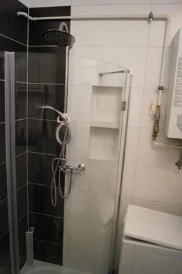 a shower with a glass door in a bathroom at Old Town Apartment Kazimierz in Kraków