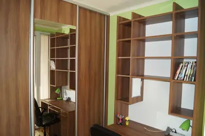 an office room with wooden shelves and a mirror at Old Town Apartment Kazimierz in Kraków