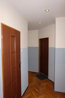 a room with two black doors and yellow walls at Pokoje Gościnne 