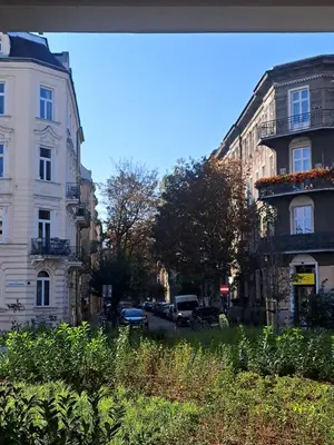 a city street with buildings and cars on the road at Apartament Bonerowska Blue in Kraków