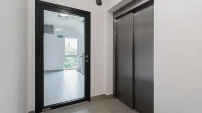 a black door in a room with a hallway at Banacha, Sun & Snow in Kraków