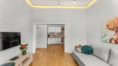 a living room with a couch and a table at Krupnicza Apartment by VSI in Kraków