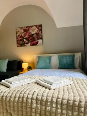 a bedroom with a bed with two towels on it at BD KRAKOW Apart Hotel in Kraków