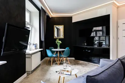 a living room with a blue couch and a table at Apartament Marylin in Kraków