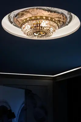 a chandelier hanging from a ceiling in a room at Apartament Marylin in Kraków