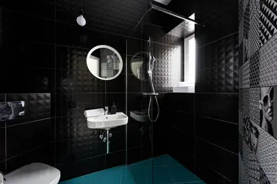 a black bathroom with a sink and a mirror at Apartament Marylin in Kraków