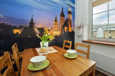 a dining room table with a view of a city at Cosy Studio in Kraków