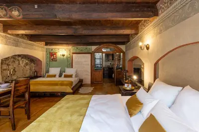a bedroom with two beds and a desk in a room at 500 Year House - Kraków Old Town - Historic Apartments by Staymoovers in Kraków