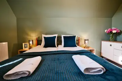 a bedroom with a bed with two towels on it at Vista Jaśmin 22 by Housine in Zator