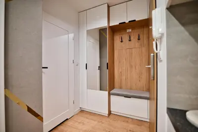 a bathroom with white cabinets and a wooden door at Vista Jaśmin 22 by Housine in Zator