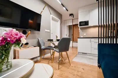 a kitchen and living room with a table and chairs at Vista Jaśmin 22 by Housine in Zator