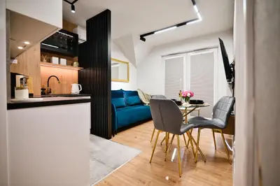 a kitchen and living room with a table and chairs at Vista Jaśmin 22 by Housine in Zator