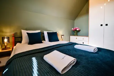 a bedroom with a large bed with towels on it at Vista Jaśmin 22 by Housine in Zator