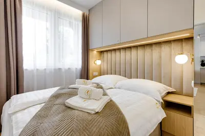 a bedroom with two beds with towels on them at BABIA GÓRA Dream Apart in Zawoja