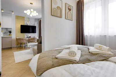 a bedroom with a bed with towels on it at BABIA GÓRA Dream Apart in Zawoja