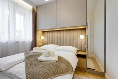a bedroom with two beds with towels on them at BABIA GÓRA Dream Apart in Zawoja