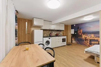 a kitchen with a wooden table in a room at Old Town Gateway in Kraków