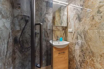 a bathroom with a sink and a shower at Old Town Gateway in Kraków
