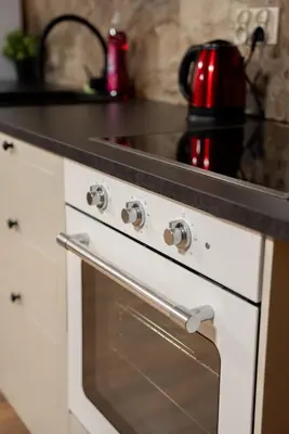 a white stove top oven with a black counter top at Old Town Gateway in Kraków