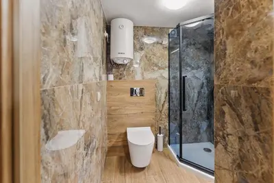a bathroom with a toilet and a shower at Old Town Gateway in Kraków
