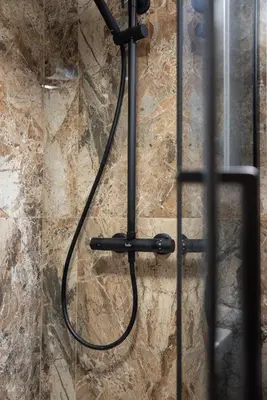 a shower with a hose hanging on a wall at Old Town Gateway in Kraków
