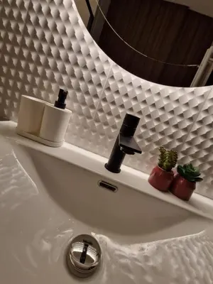 a bathroom sink with two candles and a mirror at Mieszkanie Centralna Tauron Arena in Kraków
