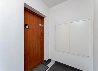 a wooden door in a room with a mirror at Lindego Park Comfy Studio by BookingHost in Kraków