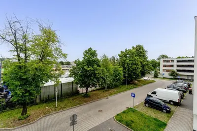a street with cars parked in a parking lot at Lindego Park Comfy Studio by BookingHost in Kraków