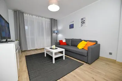 a living room with a couch and a table at JJ Apartment Zator Energylandia in Zator