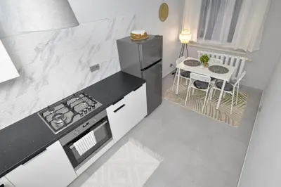 a kitchen with a stove and a small table at JJ Apartment Zator Energylandia in Zator