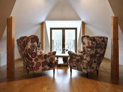 two chairs and a table in a room with a window at Babie Zacisze in Zawoja