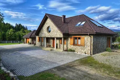 a stone house with a brick driveway at Babie Zacisze in Zawoja