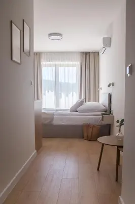 a bedroom with a bed and a window at Nad Jeziorem in Rożnów