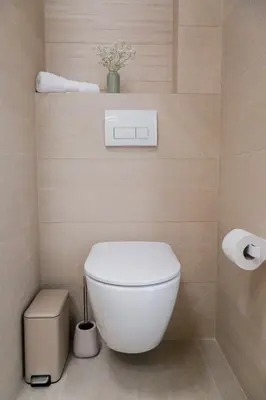 a bathroom with a white toilet and some toilet paper at Nad Jeziorem in Rożnów