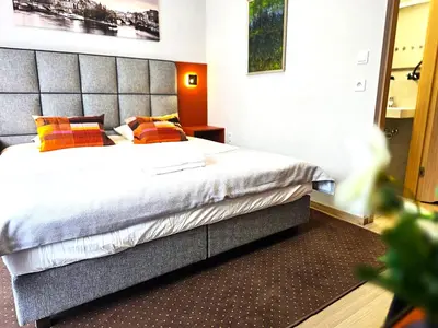 a bedroom with a bed with a large headboard at Royal Kątowa Apartment in Kraków